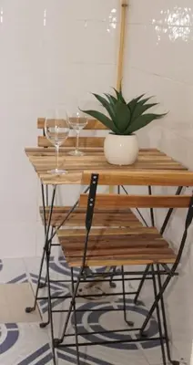 a table with two glasses and a potted plant on it at Casa de ensueño a 5 minutos de la playa in Valencia