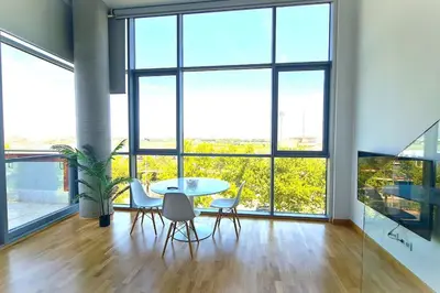 a dining room with a table and chairs and large windows at E-Arenas Apartment with terrace in Edificio Arenas in Valencia