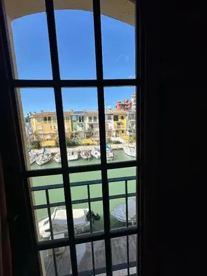 a view of a harbor from a window at Port Saplaya 2 habitaciones Valencia in Port Saplaya