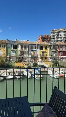 a balcony with a view of a marina with boats at Port Saplaya 2 habitaciones Valencia in Port Saplaya