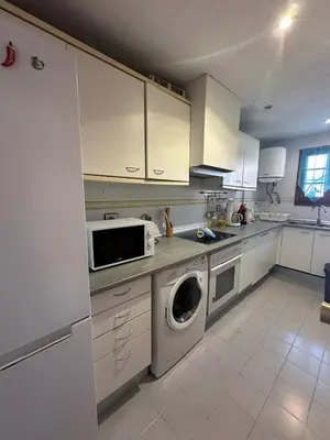 a kitchen with a washing machine and a microwave at Port Saplaya 2 habitaciones Valencia in Port Saplaya