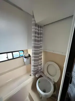 a bathroom with a toilet and a window at Barco muy espacioso con dos terrazas Valencia CENTRO!! in Valencia