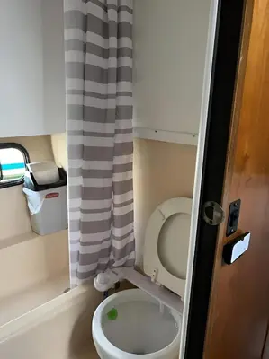 a small bathroom with a toilet and a curtain at Barco muy espacioso con dos terrazas Valencia CENTRO!! in Valencia