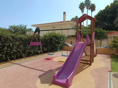 a playground with a slide in a backyard at Luminoso estudio con vistas al mar in Las Canteras