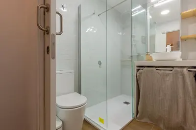a bathroom with a toilet and a glass shower at Nuevo loft cerca del centro y Ciudad Artes y Ciencias in Valencia