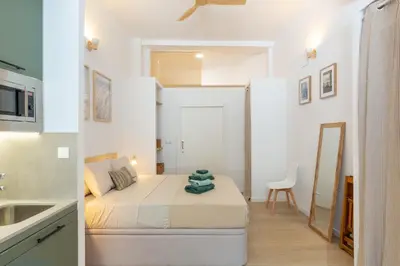 a small bedroom with a bed and a bathroom at Nuevo loft cerca del centro y Ciudad Artes y Ciencias in Valencia