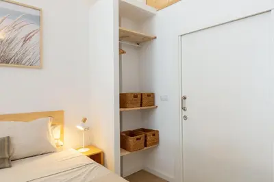 a bedroom with a bed and a sliding door at Nuevo loft cerca del centro y Ciudad Artes y Ciencias in Valencia