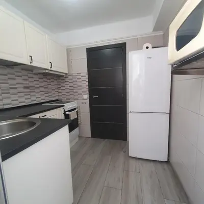 a kitchen with a white refrigerator and a sink at Apartamento Berenguer in Cullera