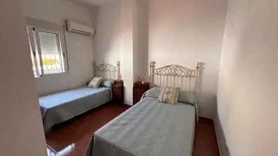 a small bedroom with two beds and a window at El Siprer in Anna