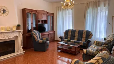 a living room with chairs and a tv and a fireplace at El Siprer in Anna
