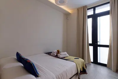 a bedroom with a bed with a teddy bear on it at Osito Hub - Justo y Pastor in Valencia
