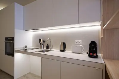 a kitchen with white cabinets and a sink at Osito Hub - Justo y Pastor in Valencia