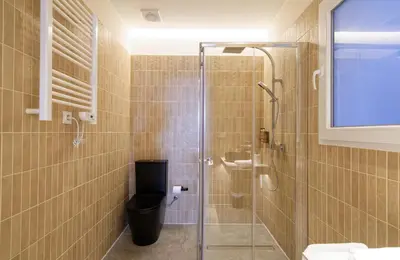 a bathroom with a toilet and a glass shower at Osito Hub - Justo y Pastor in Valencia