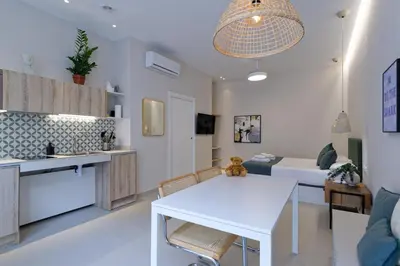 a kitchen and living room with a white table at Osito Hub - Esteban Ballester in Valencia