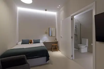 a bedroom with a bed and a bathroom with a toilet at Osito Hub - Esteban Ballester in Valencia