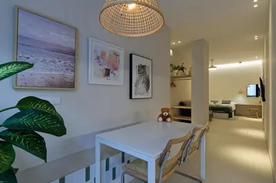 a dining room with a white table and chairs at Osito Hub - Esteban Ballester in Valencia