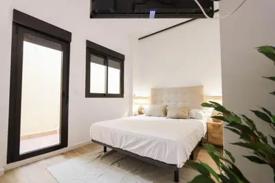 a bedroom with a bed and a large window at Roca 26 in Valencia