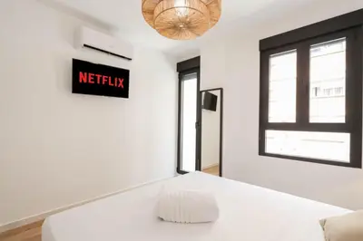 a white room with a white couch and a window at Roca 26 in Valencia