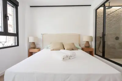 a bedroom with a large white bed with towels on it at Roca 26 in Valencia