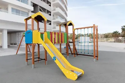 a playground with a slide in front of a building at Gran Canet Vlado in Canet de Berenguer