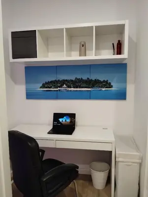 a desk with a laptop computer on top of it at Apartamento Plaza Palmeras2 in Burjasot