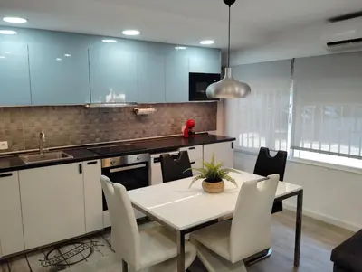a kitchen with a table and chairs in a room at Apartamento Plaza Palmeras2 in Burjasot
