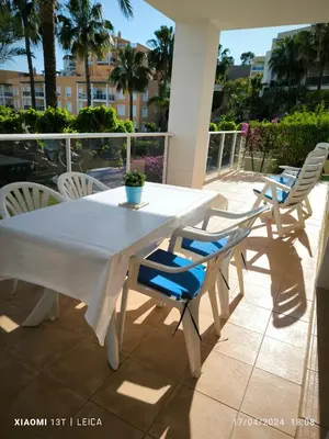 a white table and chairs on a balcony at Apartamento Masia Racó Cullera in Cullera