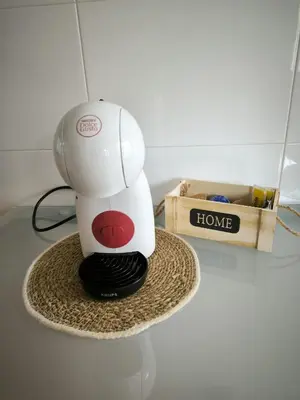 a hair dryer sitting on a hat on a table at Apartamento Masia Racó Cullera in Cullera