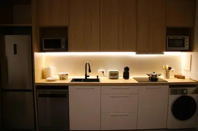 a kitchen with a sink and a counter with lights at Flats Benimaclet in Valencia