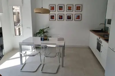 a kitchen with a table and two stools at Romantic Apartment in Cabanyal by Virkin Suites in Valencia