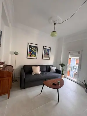 a living room with a couch and a coffee table at Romantic Apartment in Cabanyal by Virkin Suites in Valencia