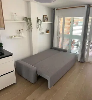 a bedroom with a bed in a room with a window at vivienda independiente in Canet de Berenguer