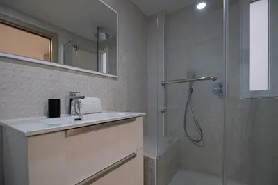 a bathroom with a shower and a sink and a mirror at GuestReady - Valencia Bliss near Malvarrosa Beach in Valencia