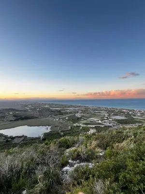 a view from the top of a hill at sunset at Apartamento con increíbles vistas a la bahía de Cullera in Faro de Cullera