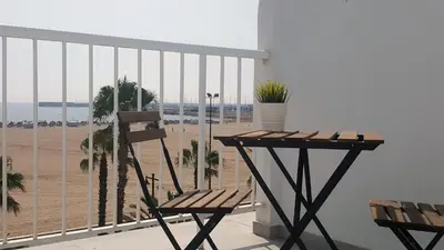 a balcony with a bench and a view of the beach at Sol Playa in Valencia