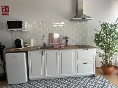 a kitchen with white cabinets and a counter top at ALZIRA BONiTA SUITE ViP jacuzzi in Alzira