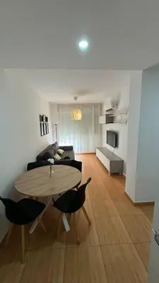 a living room with a table and a couch at Apartamentos Felip 3 in Burriana