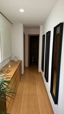 a hallway with paintings on the walls of a room at Apartamentos Felip 3 in Burriana
