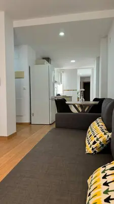 a living room with a couch and a kitchen at Apartamentos Felip 3 in Burriana