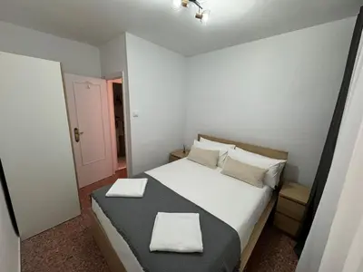 a bedroom with a bed with two towels on it at Apartments del sol in Cullera