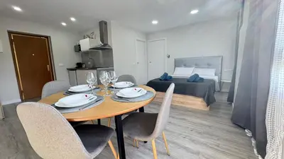 a dining room with a table and chairs and a bed at Versus Apartments near City of Arts III in Valencia