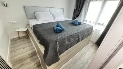 a bedroom with a bed with two blue towels on it at Versus Apartments near City of Arts III in Valencia