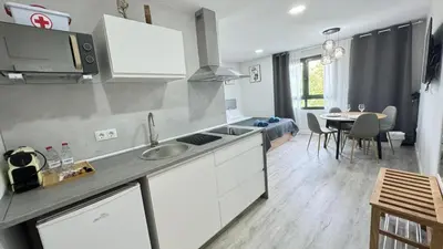 a kitchen with a sink and a table in a room at Versus Apartments near City of Arts III in Valencia