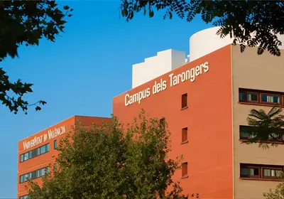 a building with a sign on the side of it at Turia Gardens Rooms - Authentic Valencia Downtown Parklife - VLC Urban Rental in Valencia