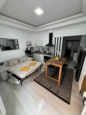 a living room with a bed and a table at Anthracita in Valencia