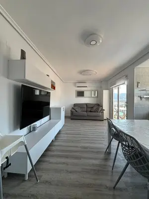 a living room with a couch and a table at Seaviews Los Olivos in Cullera