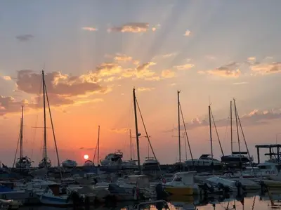 a group of boats docked in a marina at sunset at La Llar45 , Relájate junto al mar in Playa Pobla de Farnals