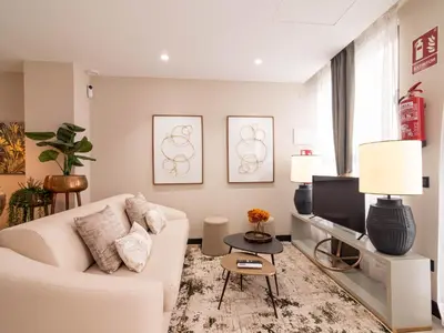 a living room with a white couch and a tv at MD Nou Mestalla in Valencia