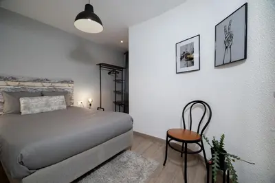a bedroom with a bed and a chair in it at Apartment in El Mercat in Valencia