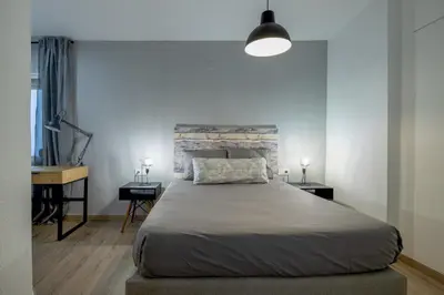 a bedroom with a large bed and two night stands at Apartment in El Mercat in Valencia